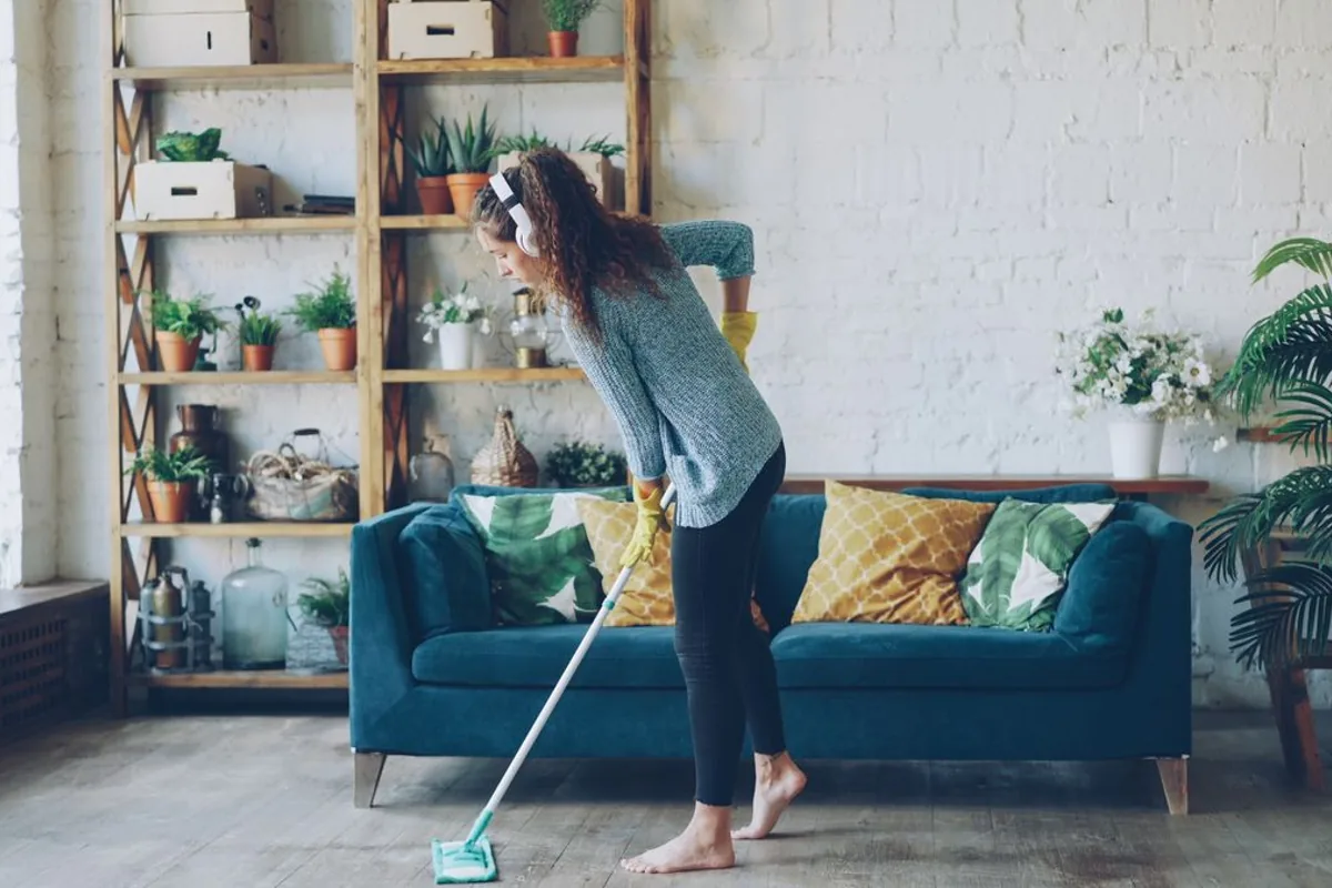 Person mopping a living room floor
