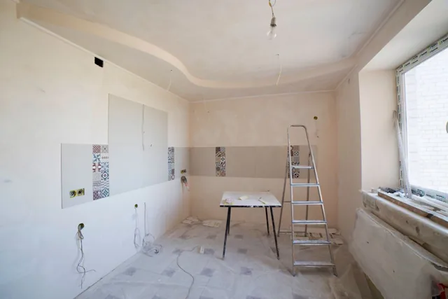 Home interior undergoing renovation with ladder and tools